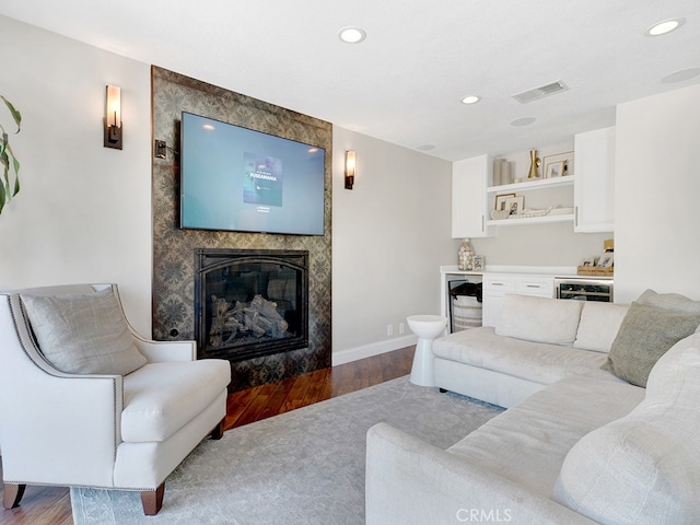 living room with light hardwood / wood-style flooring and a premium fireplace