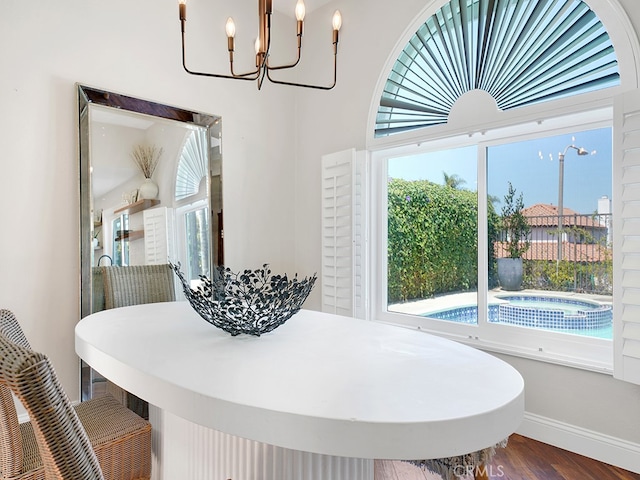 dining room with wood-type flooring and a chandelier