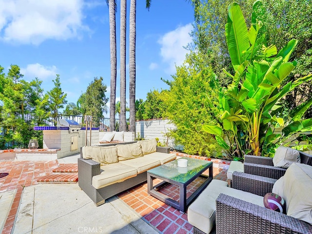 view of patio with an outdoor hangout area and grilling area