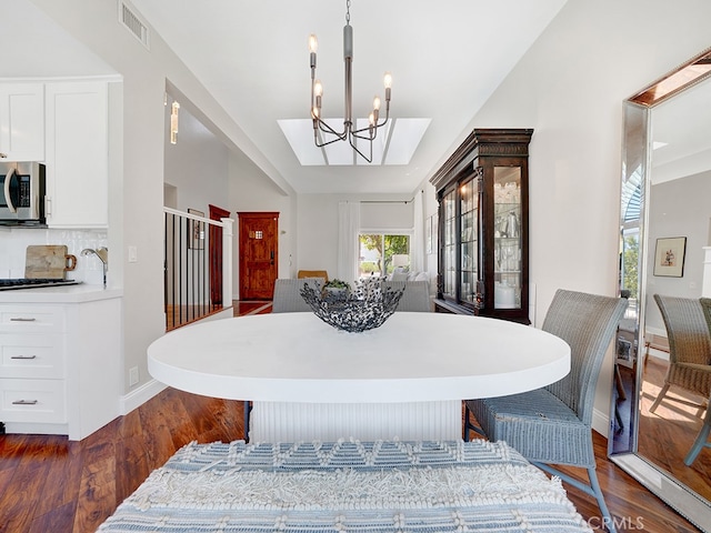 dining space featuring a chandelier and dark wood-type flooring