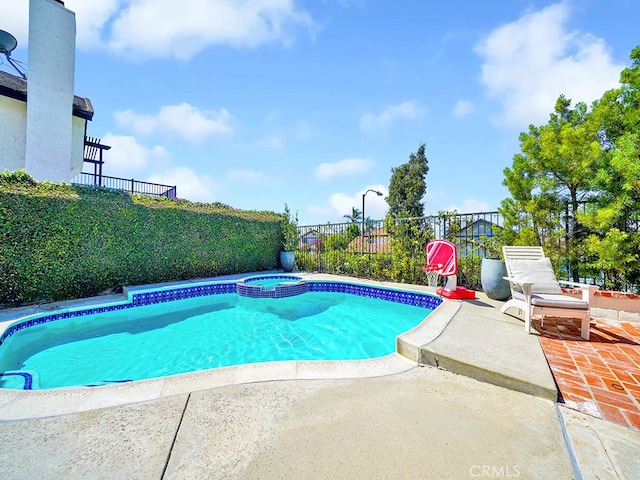 view of pool featuring a patio and an in ground hot tub