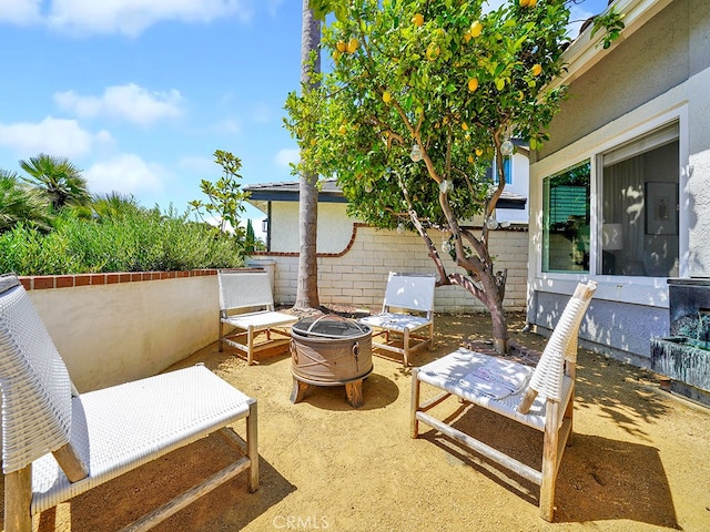 view of patio featuring an outdoor fire pit