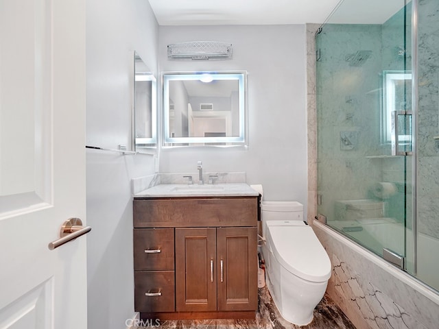 full bathroom with combined bath / shower with glass door, vanity, and toilet