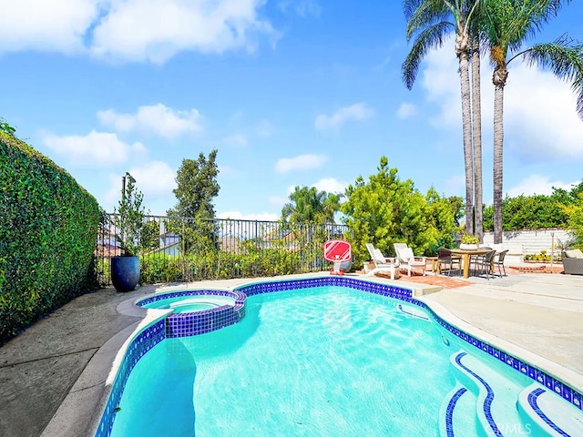 view of swimming pool with an in ground hot tub and a patio area