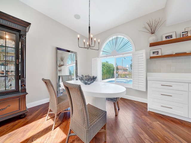 dining area featuring an inviting chandelier and dark hardwood / wood-style floors