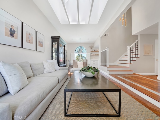 living room with wood-type flooring and a notable chandelier