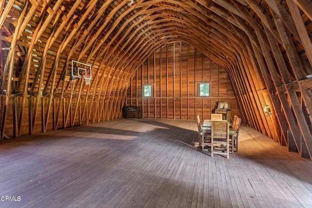 misc room with hardwood / wood-style flooring and lofted ceiling