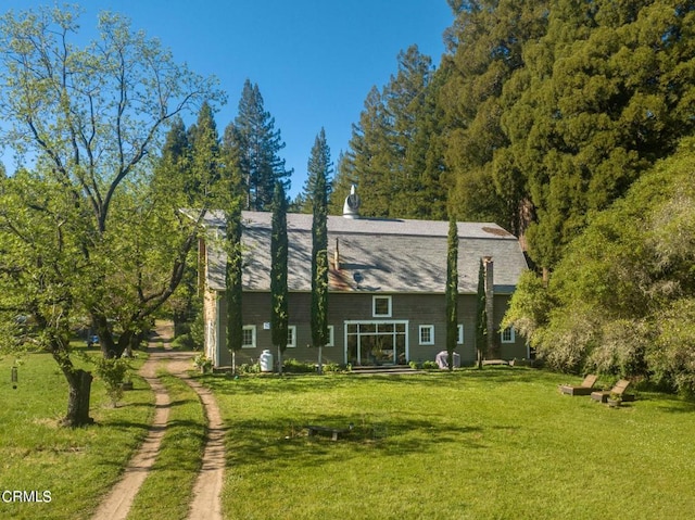 back of house with a lawn