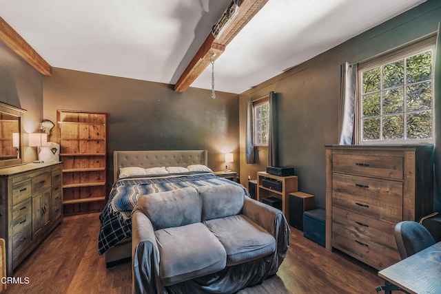 bedroom with beamed ceiling and dark hardwood / wood-style floors