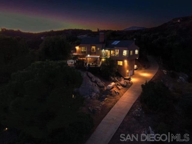 back house at dusk with a mountain view