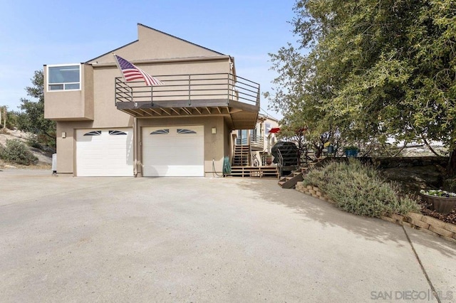 view of home's exterior featuring a garage and a balcony