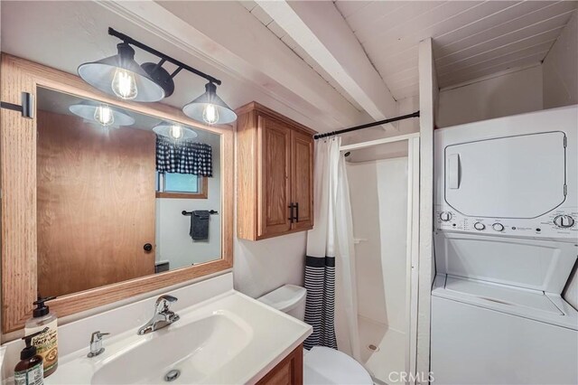 bathroom with stacked washer and dryer, walk in shower, vanity, and toilet