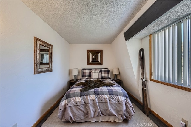 bedroom featuring a textured ceiling and carpet floors