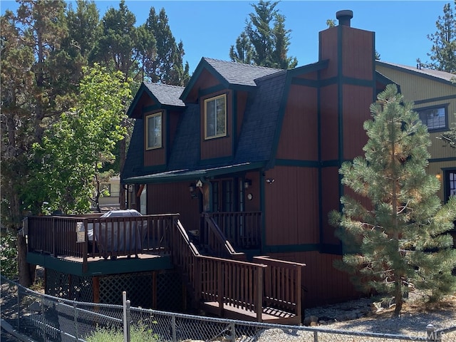 back of property featuring a wooden deck