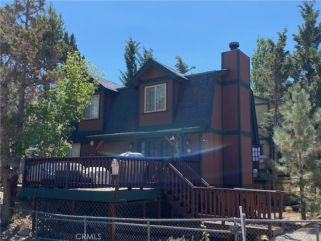 back of property with a wooden deck