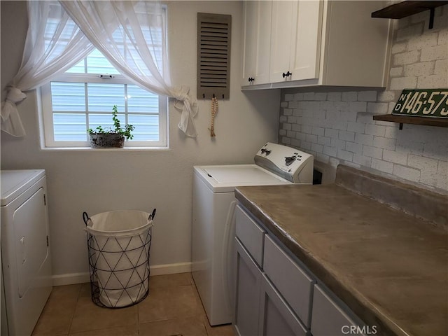11710 Paskenta Rd, Red Bluff, CA 96080 - clothes washing area with baseboards, light tile patterned flooring, independent washer and dryer, and cabinet space