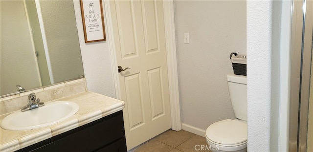 bathroom featuring tile patterned floors, vanity, and toilet