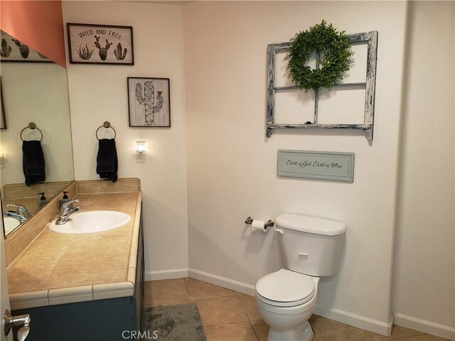 bathroom featuring vanity, toilet, and tile patterned floors