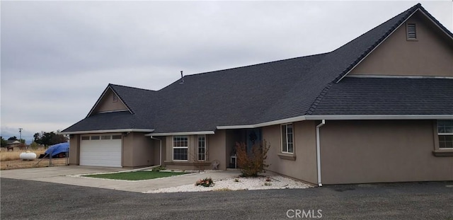 11710 Paskenta Rd, Red Bluff, CA 96080 - view of front of home with a garage, a shingled roof, concrete driveway, and stucco siding