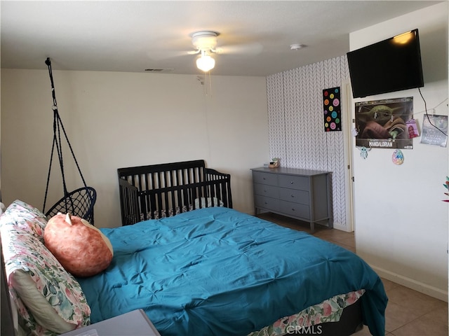 tiled bedroom featuring ceiling fan