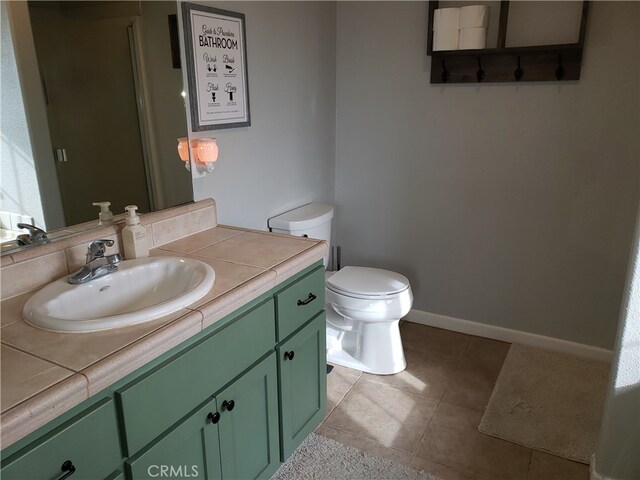 bathroom featuring vanity, toilet, and tile patterned floors