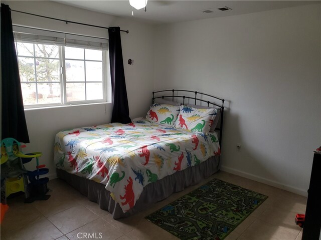 bedroom featuring ceiling fan and light tile patterned flooring