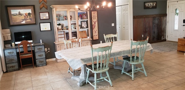 tiled dining area with a notable chandelier