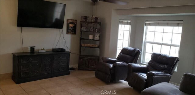 sitting room featuring ceiling fan and light tile patterned floors