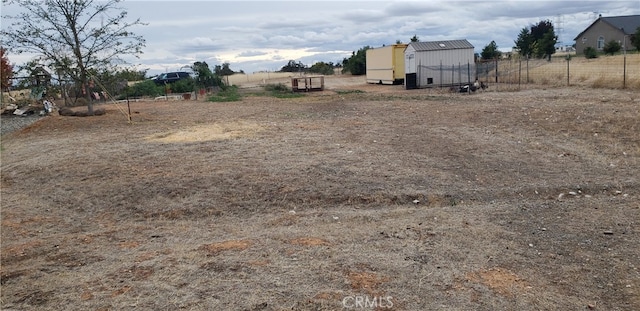 view of yard featuring a storage unit and a rural view