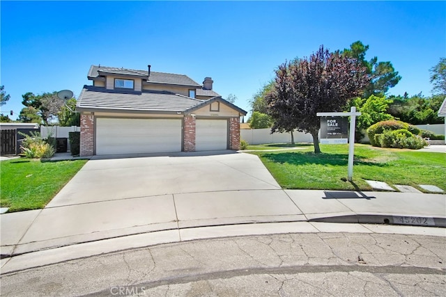 view of front of home with a garage and a front lawn