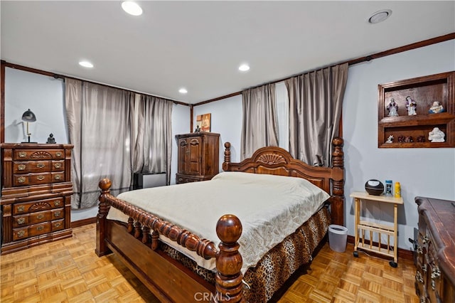 bedroom with ornamental molding and light parquet flooring