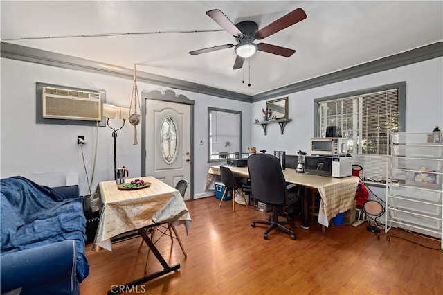 office area featuring ornamental molding, hardwood / wood-style floors, ceiling fan, and a wall unit AC