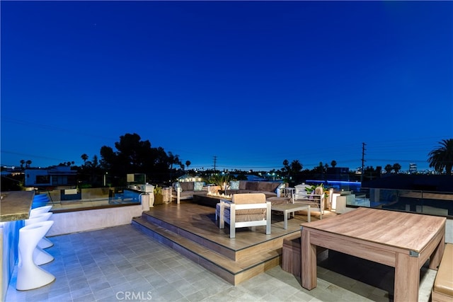 wooden terrace with a patio area