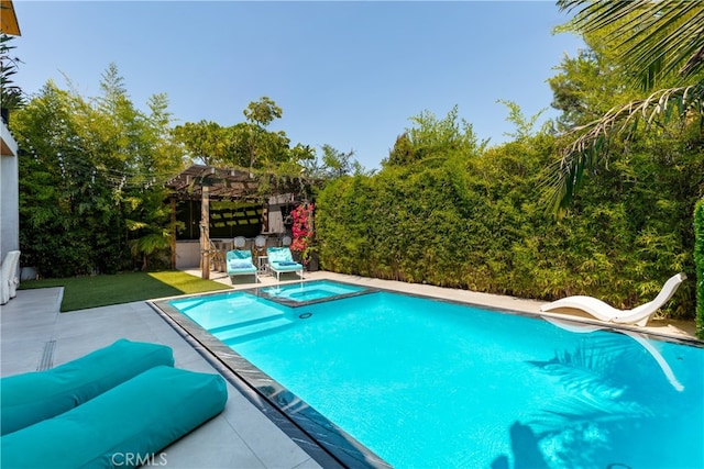 view of swimming pool featuring a patio, an outdoor hangout area, a water slide, and an in ground hot tub