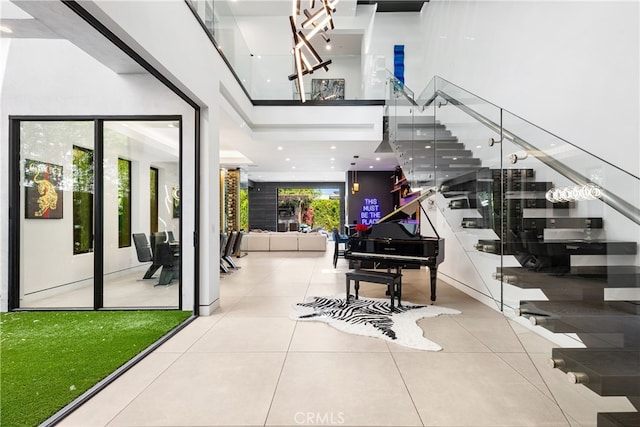 interior space featuring a towering ceiling and tile patterned floors