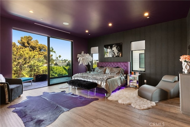 bedroom featuring light hardwood / wood-style floors and access to exterior