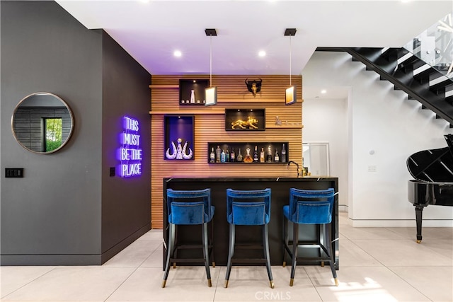 bar with light tile patterned floors and decorative light fixtures