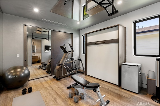 exercise area featuring light hardwood / wood-style flooring