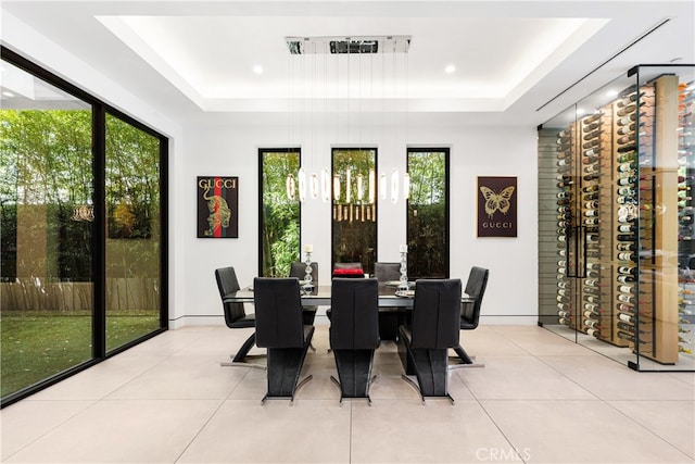 tiled dining space with a raised ceiling