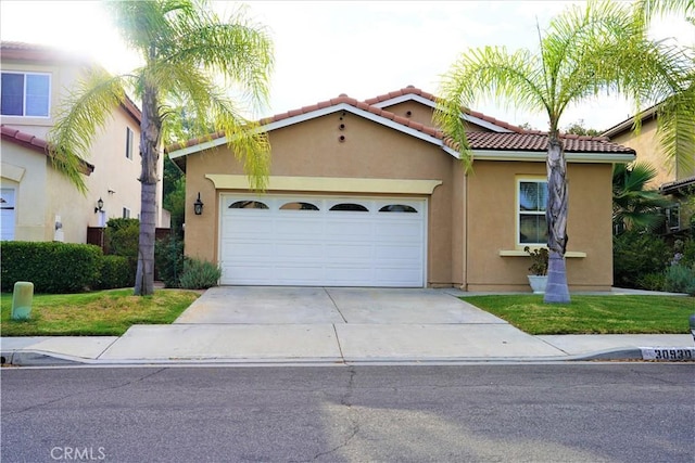 mediterranean / spanish-style house with a garage