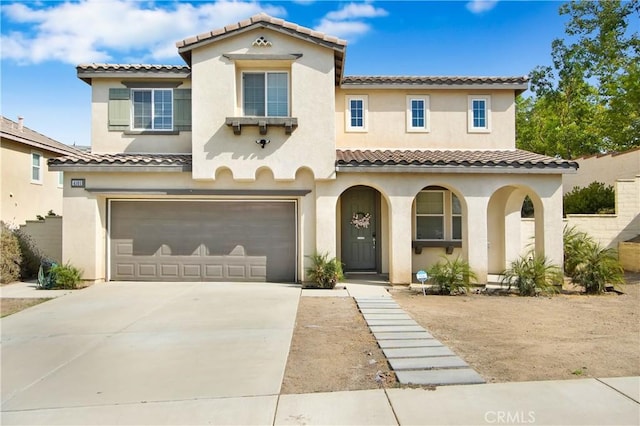 mediterranean / spanish-style home with a garage