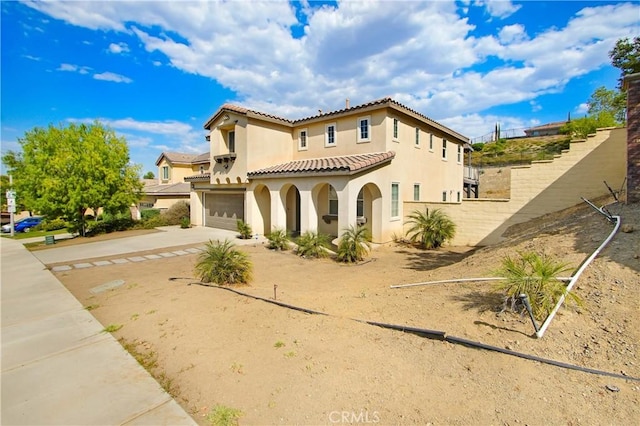 mediterranean / spanish-style house with a garage