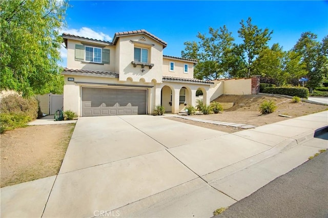 mediterranean / spanish-style home with a garage