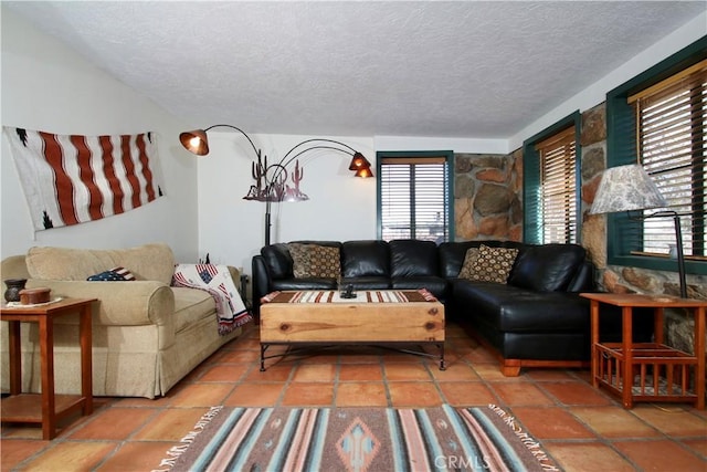 living room with tile patterned flooring and a textured ceiling