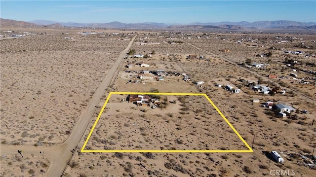 birds eye view of property featuring a mountain view