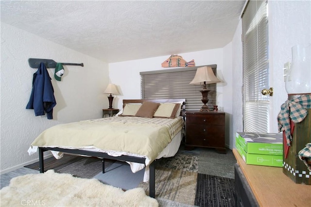 bedroom featuring carpet flooring and a textured ceiling