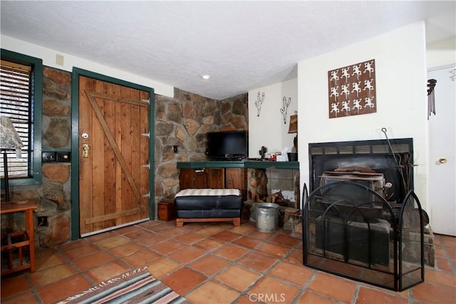 tiled living room featuring a textured ceiling