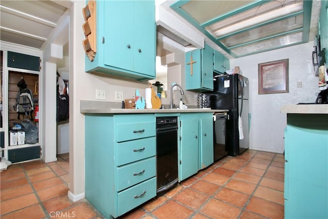 kitchen with sink, light tile patterned floors, black appliances, and blue cabinets