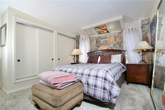 carpeted bedroom with two closets