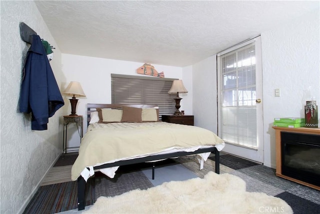 bedroom with carpet and a textured ceiling